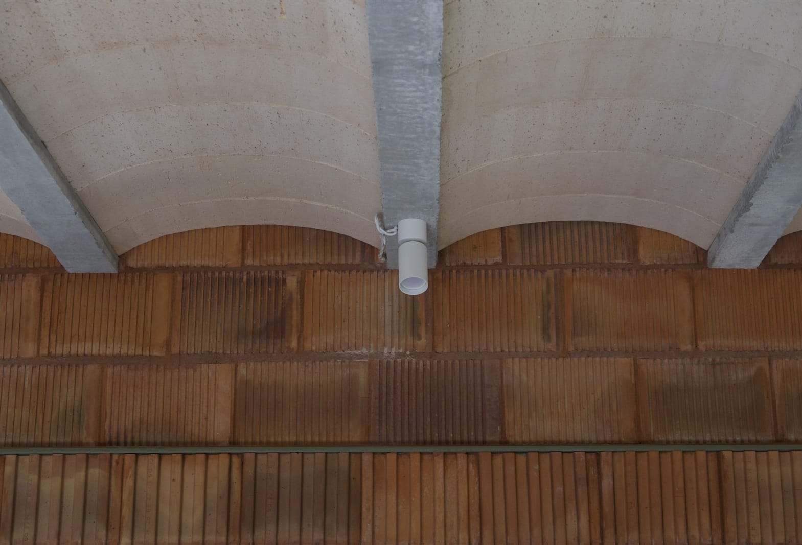Vaulted ceramic ceiling over the raw block wall — built